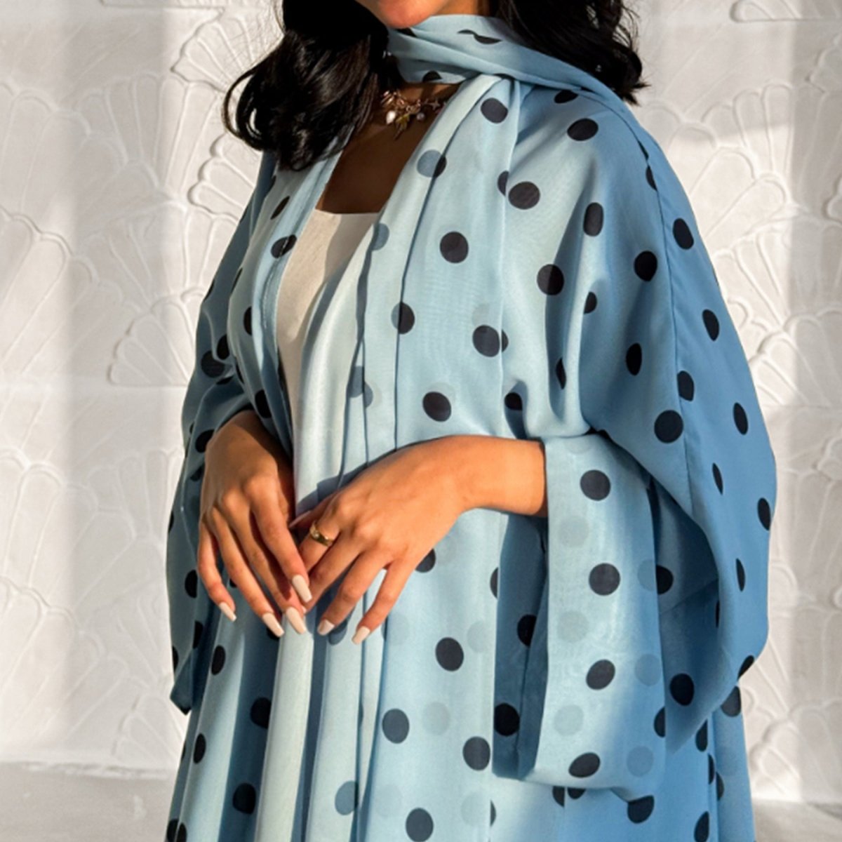 Polka dot open abaya set — holiday styling in warm natural light