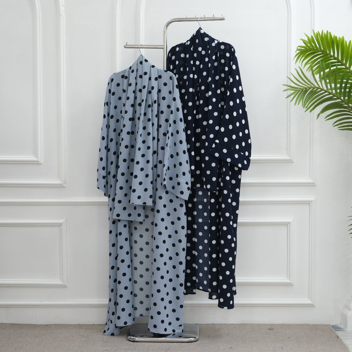 Full hem and floor-length drape of polka dot crepe abaya