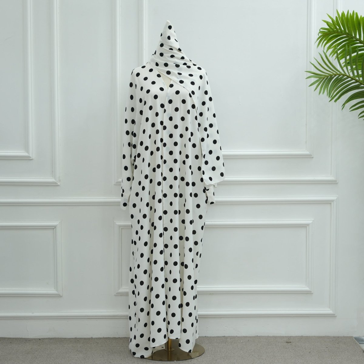 Outdoor styling shot of 2-piece polka dot abaya set in natural setting