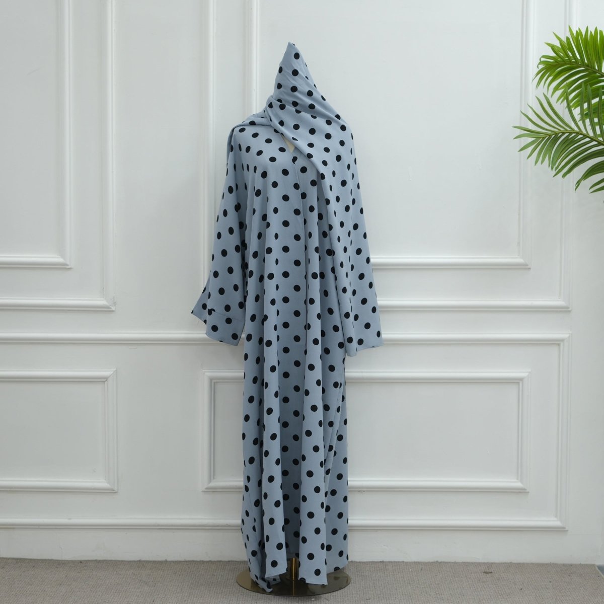 Full set view of polka dot open abaya and hijab laid flat