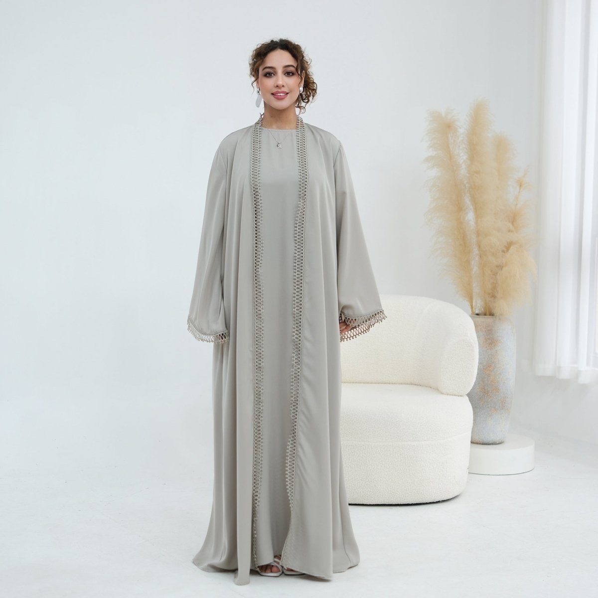 Model walking showing natural drape and movement of 3D lace open abaya