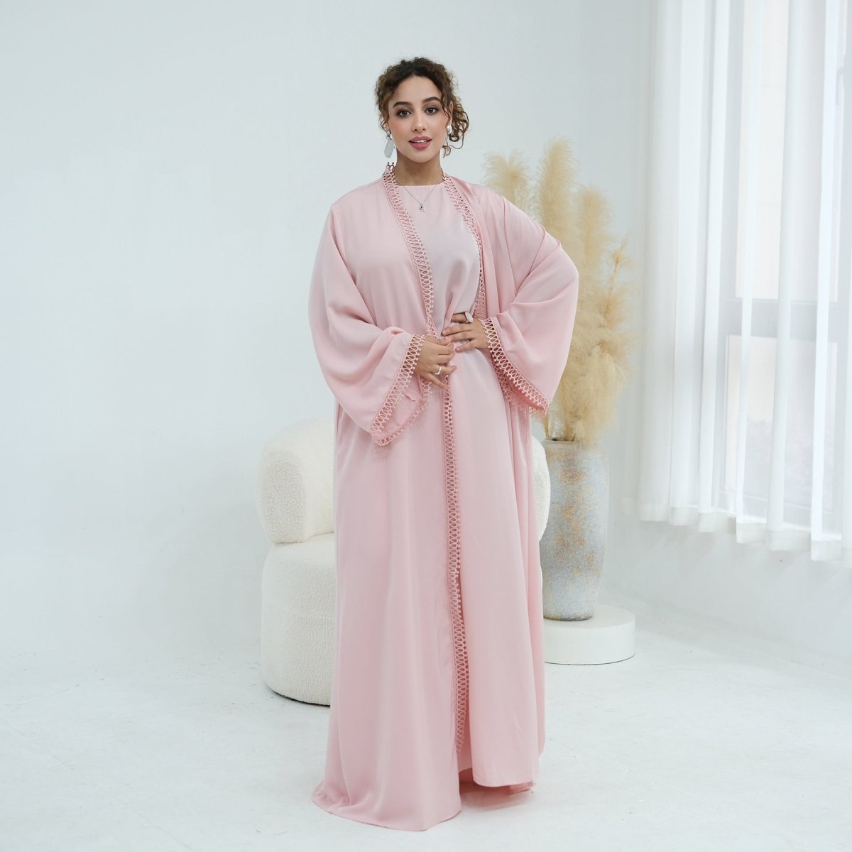 Abaya set on hanger showing structured matte fabric and lace trim