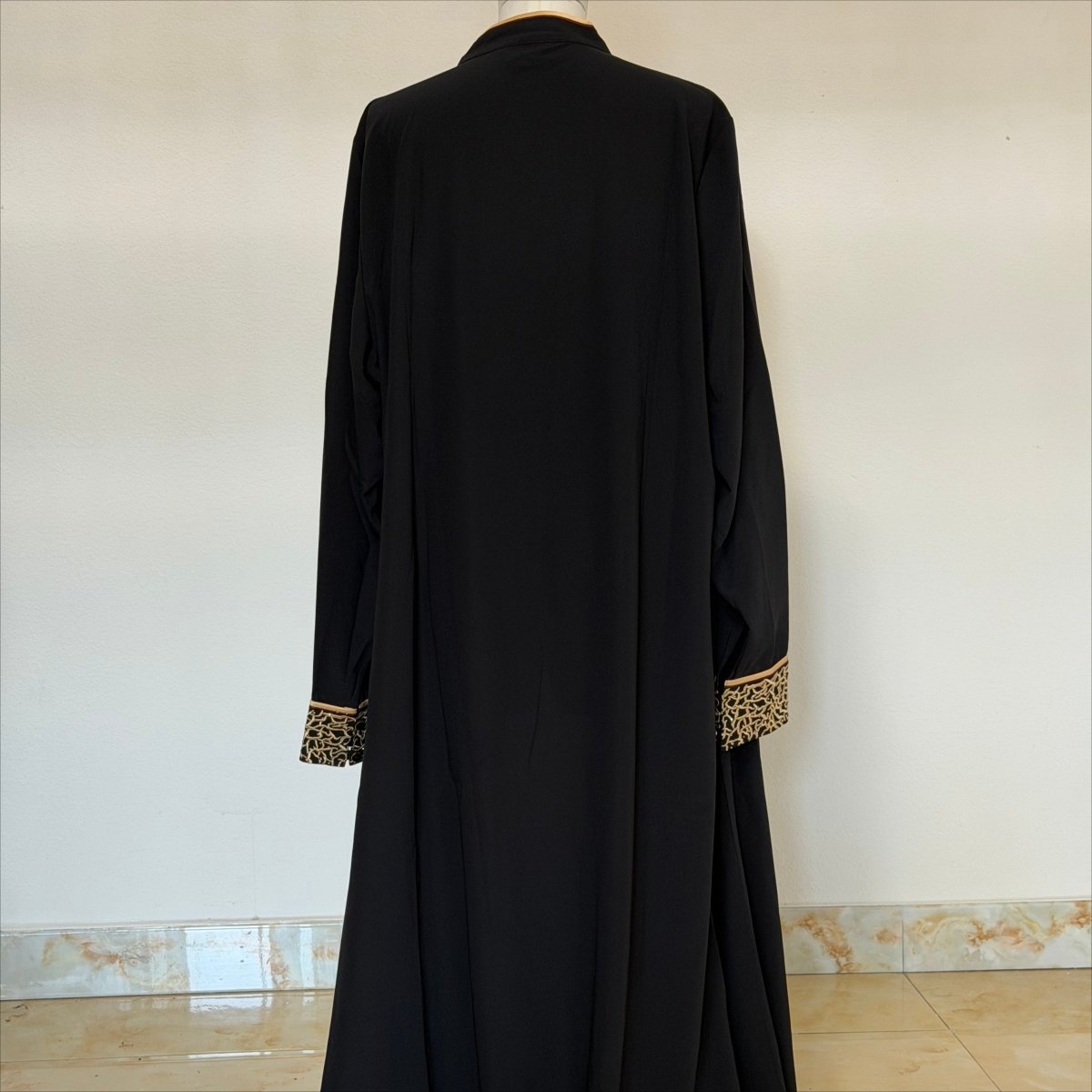 Full floor-trailing silhouette of archive black embroidered abaya