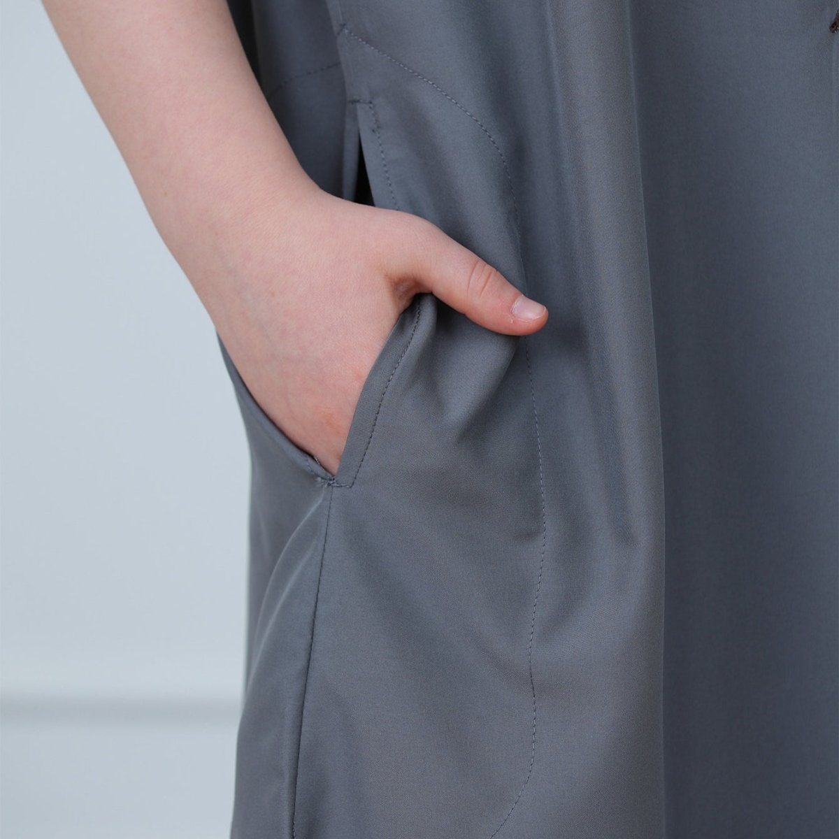 Detail of embroidered chest pocket on boys' poly-cotton blend charcoal thobe