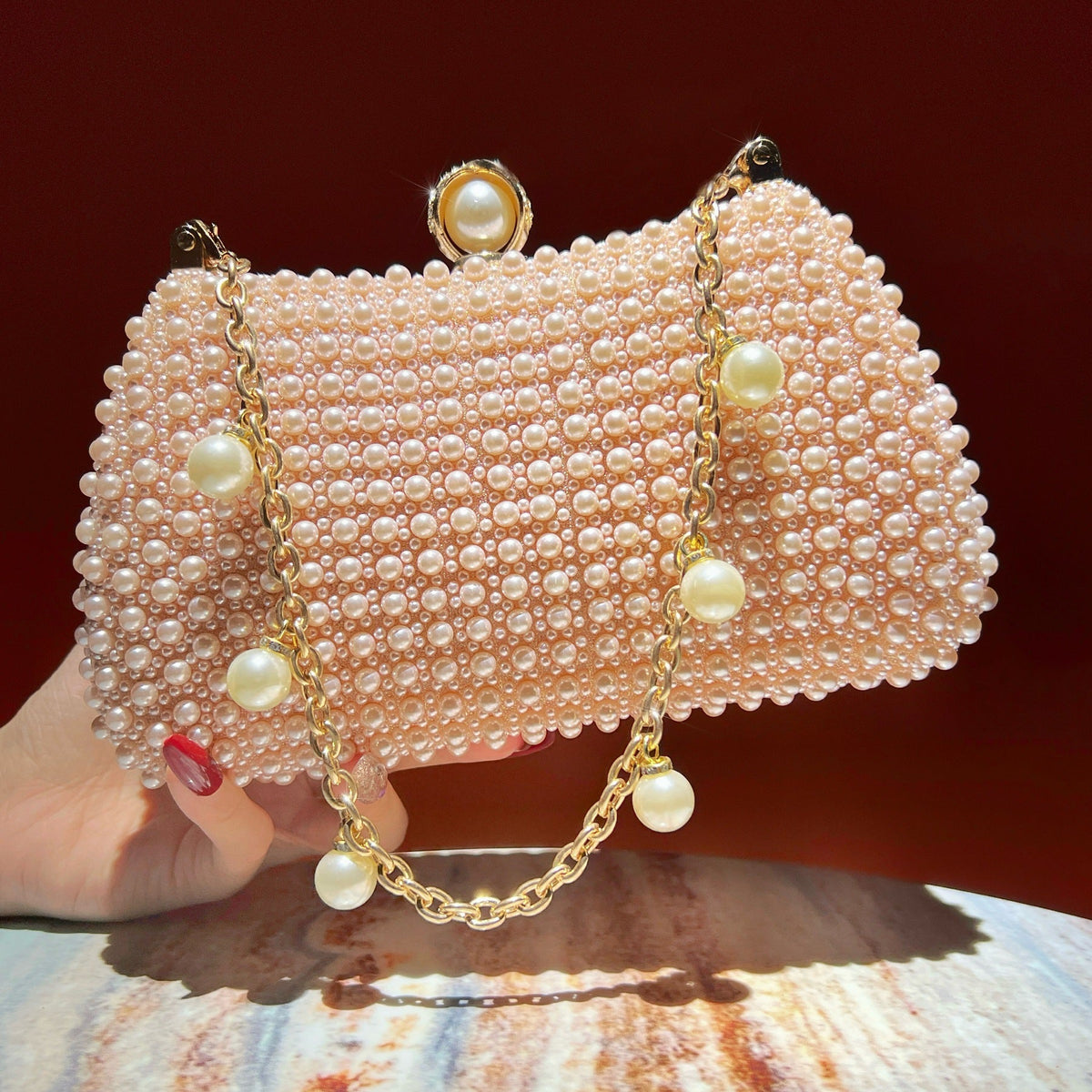 Top-handle carry view of the chic pearl evening clutch bag