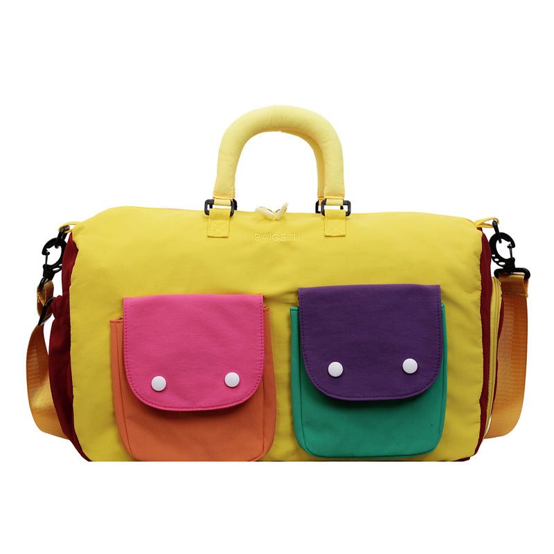Colorblock travel duffel bag styled with travel accessories