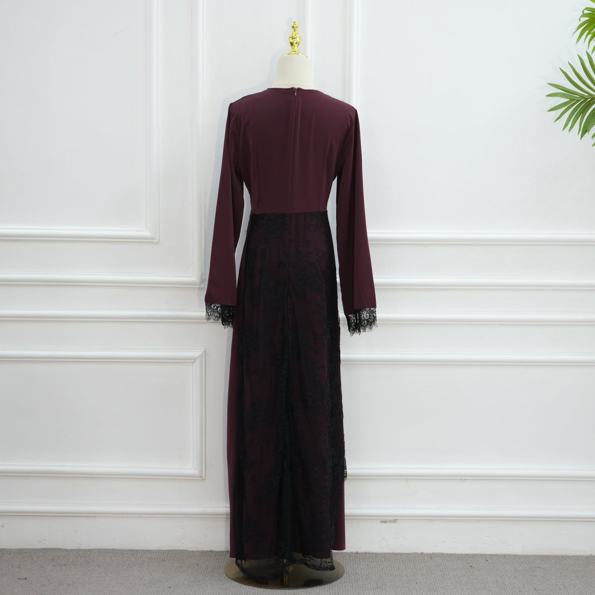 Fitted floor-length silhouette of modest dress with lace waist and cuff details