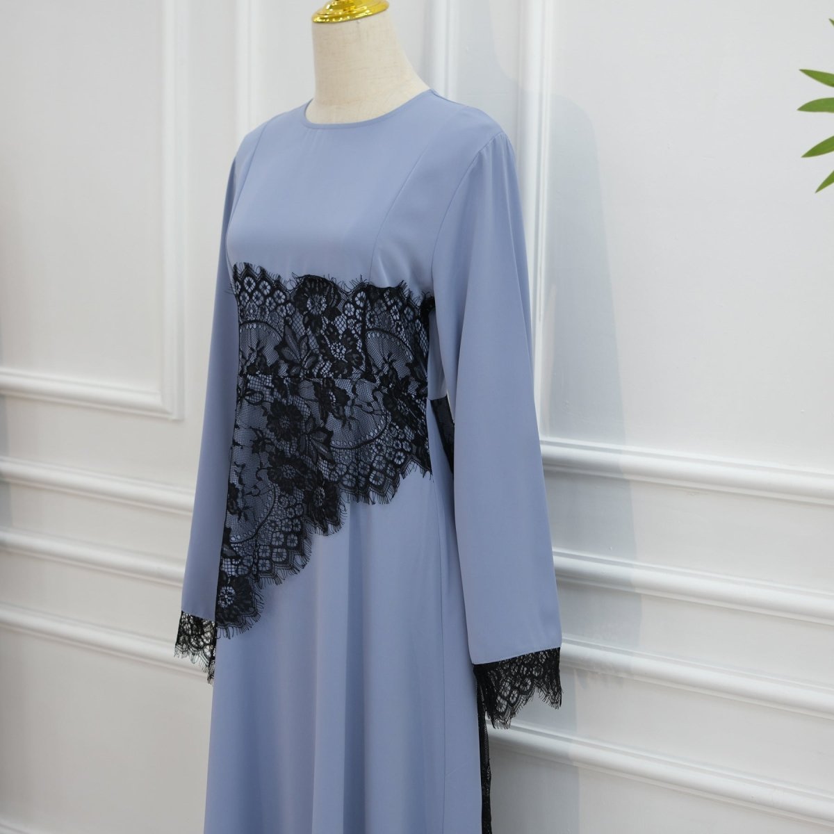 Three-quarter view of lace waist panel and structured floor-length skirt