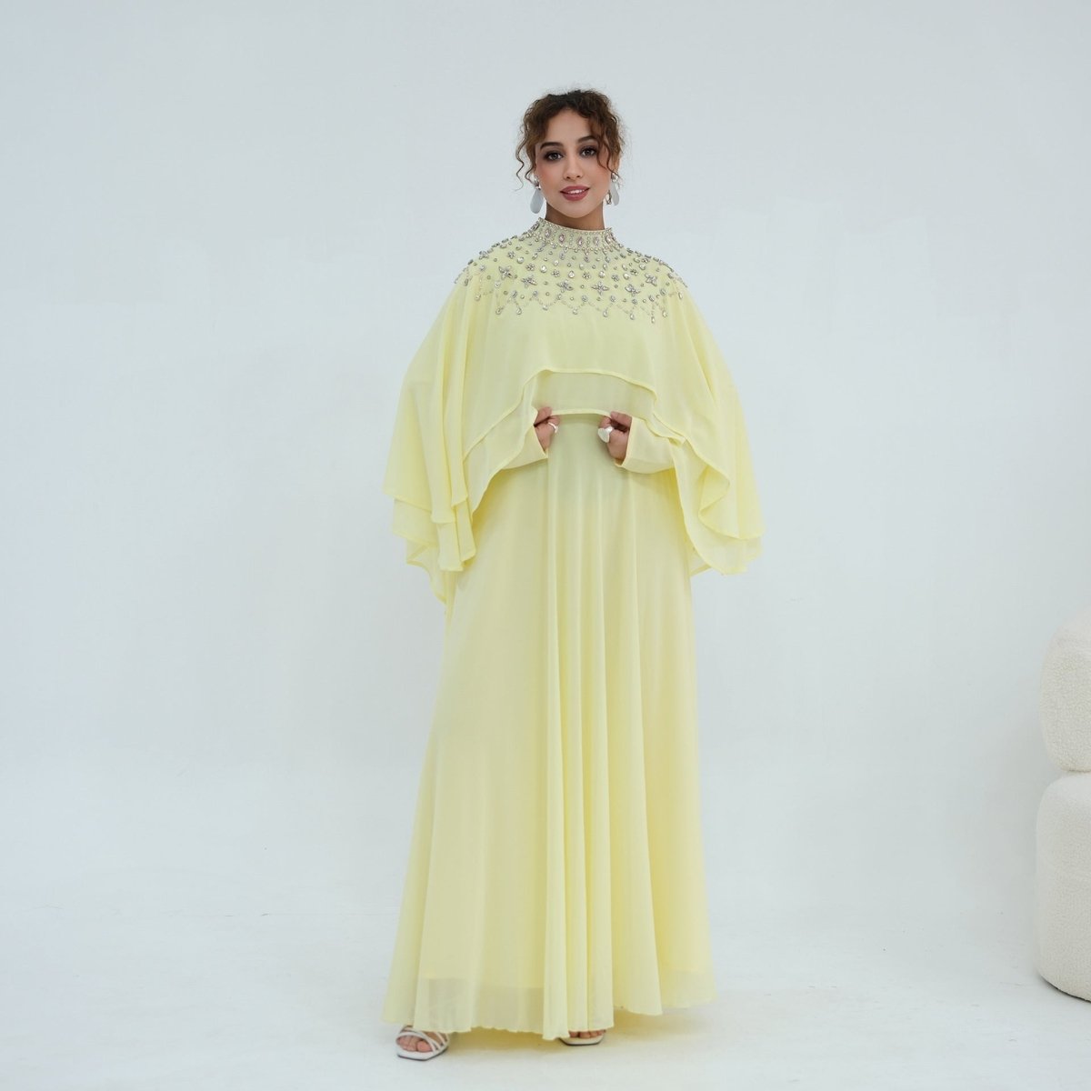 Crystal embellished cape shoulder line photographed under evening lighting