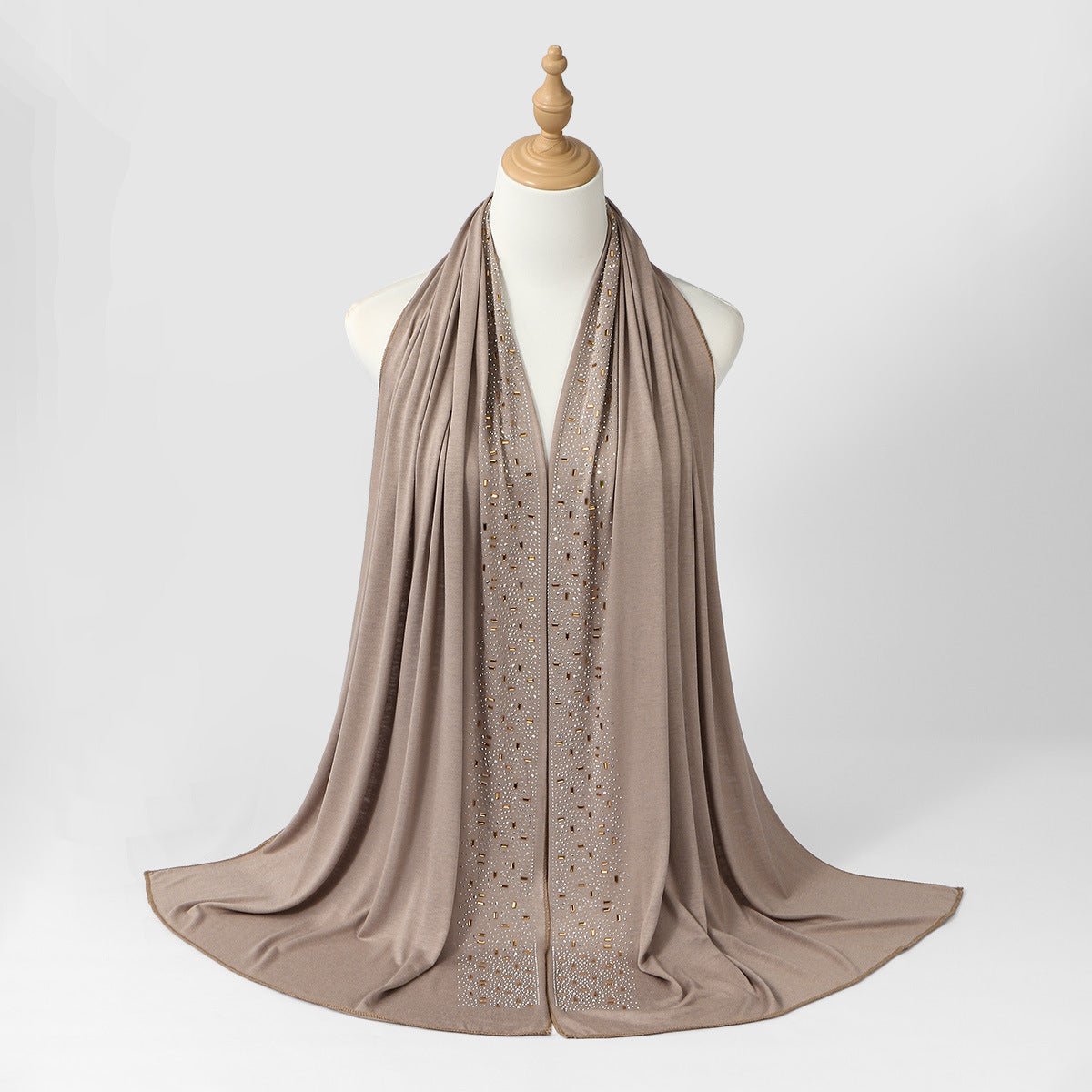 Heat-set baguette and round rhinestones caught in light on embellished hijab border