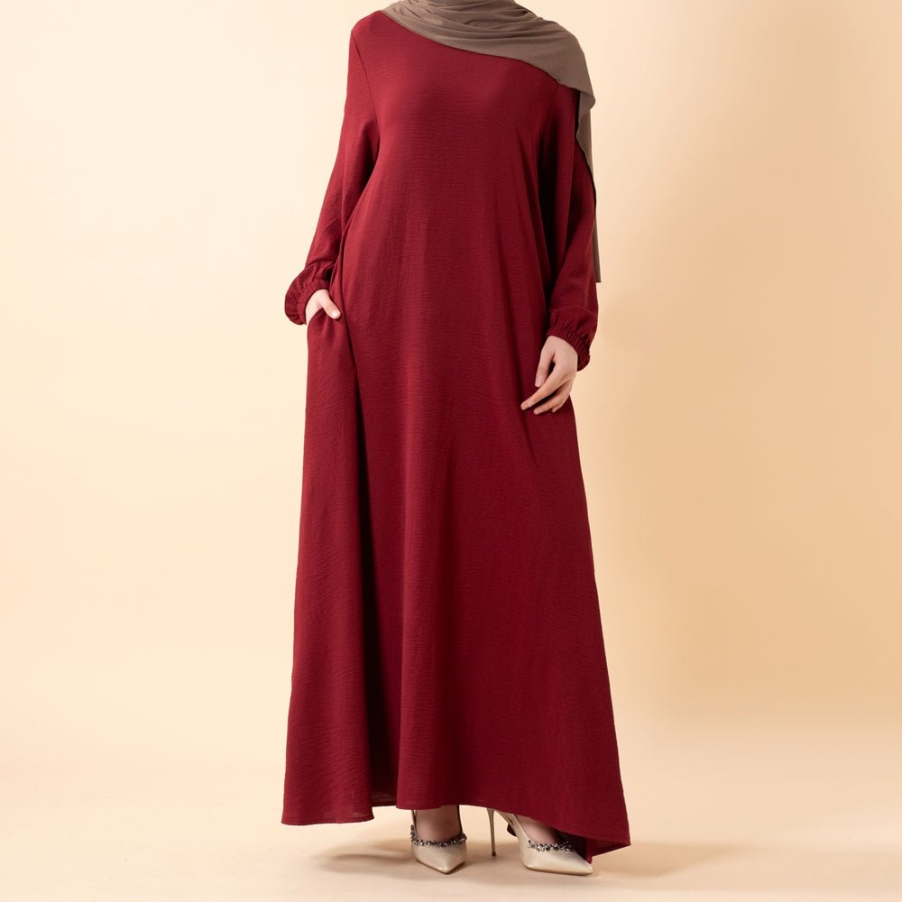 Forest olive crepe abaya with softly fitted bodice and side pockets