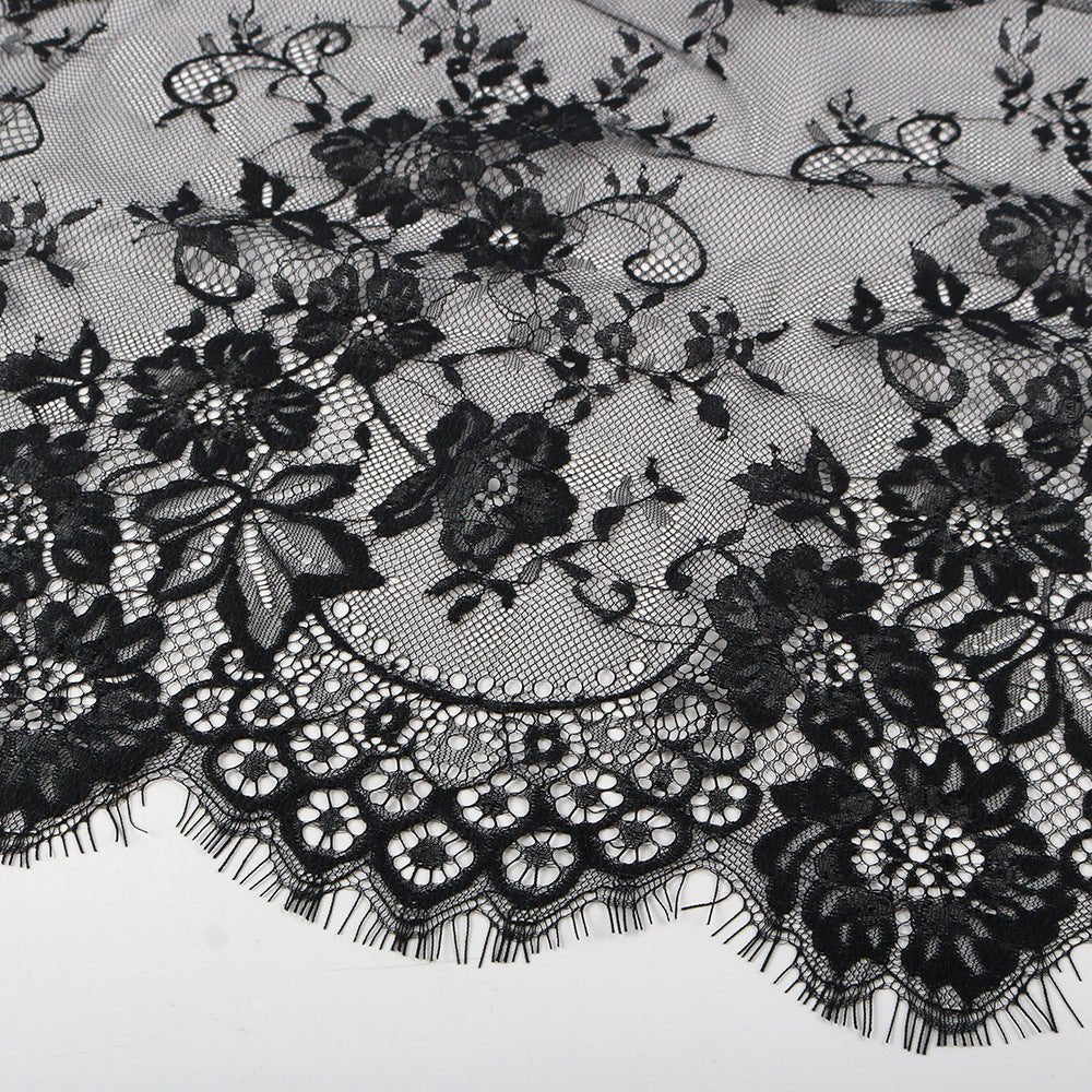 Close-up of eyelash fringe edge on white floral lace hijab