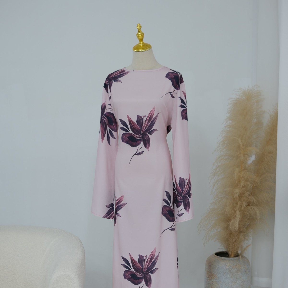 Close-up of oversized lily and botanical leaf print on fluid fabric