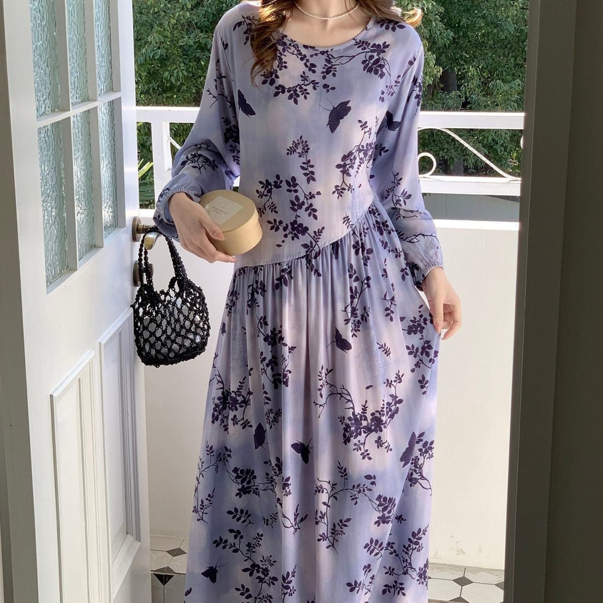 Front view of modest floral maxi dress with round neckline and full skirt