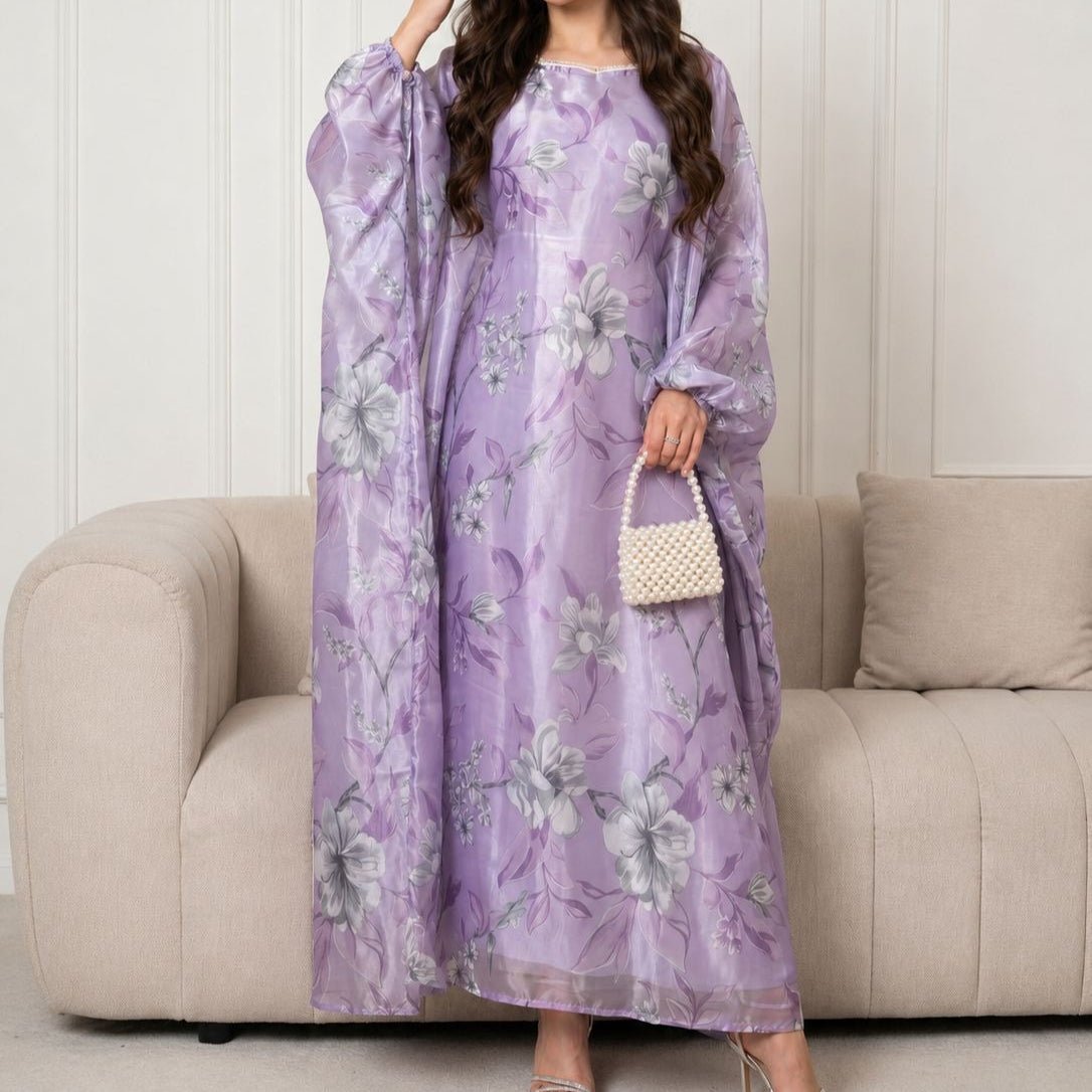 Close-up of pearl-trimmed square neckline on lavender floral abaya