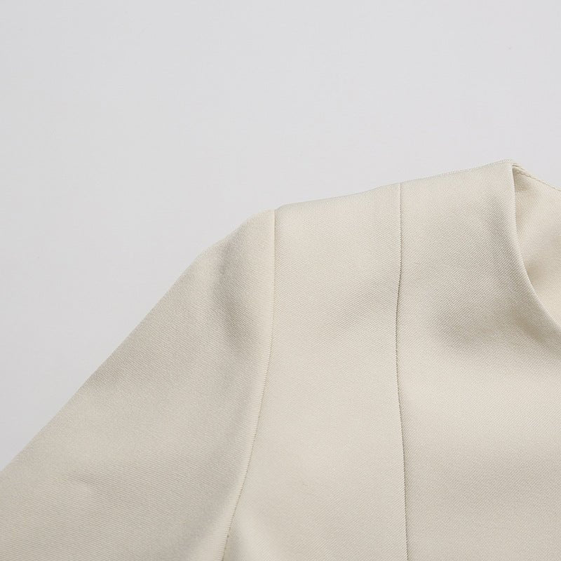 Modest tailored two-piece with luxurious gold hardware accents