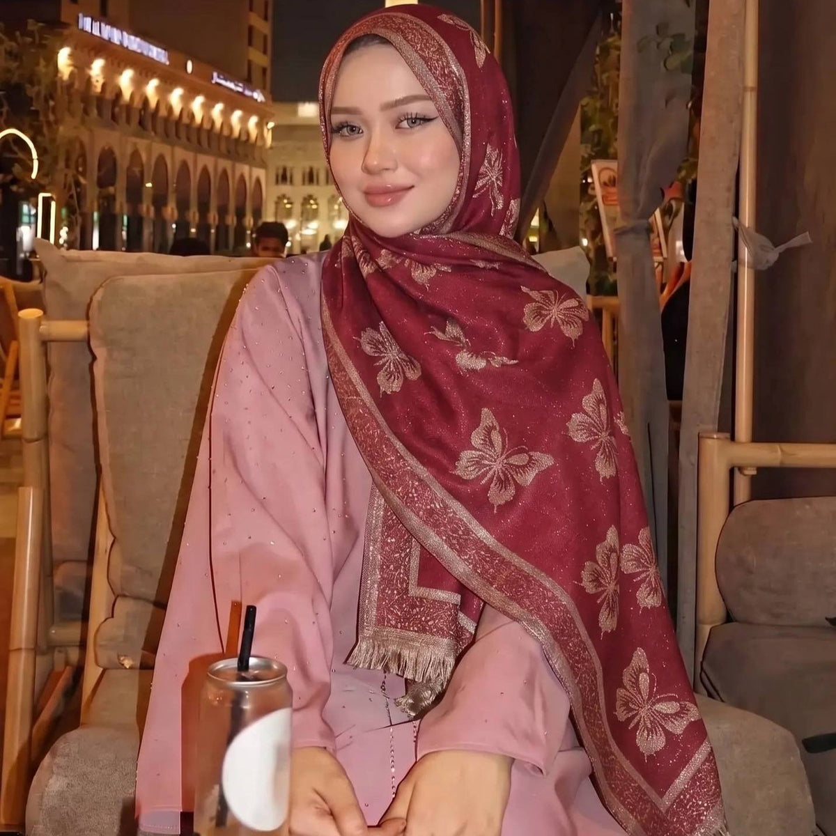 Side profile view of model wearing gold-thread jacquard hijab