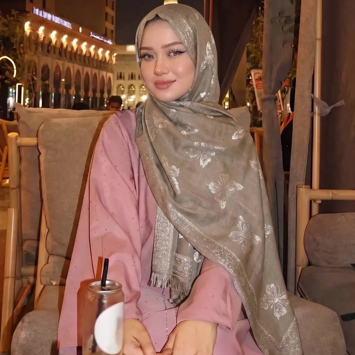 Model wearing tassel jacquard hijab draped loosely over hair and shoulders