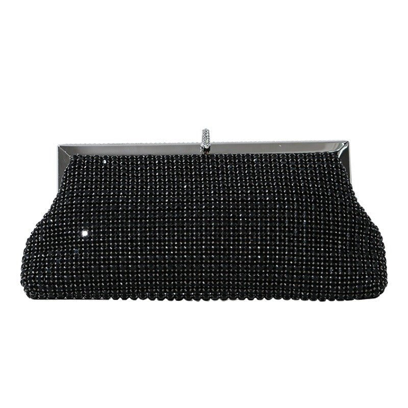 Top view of metal push-lock clasp on sparkling clutch bag