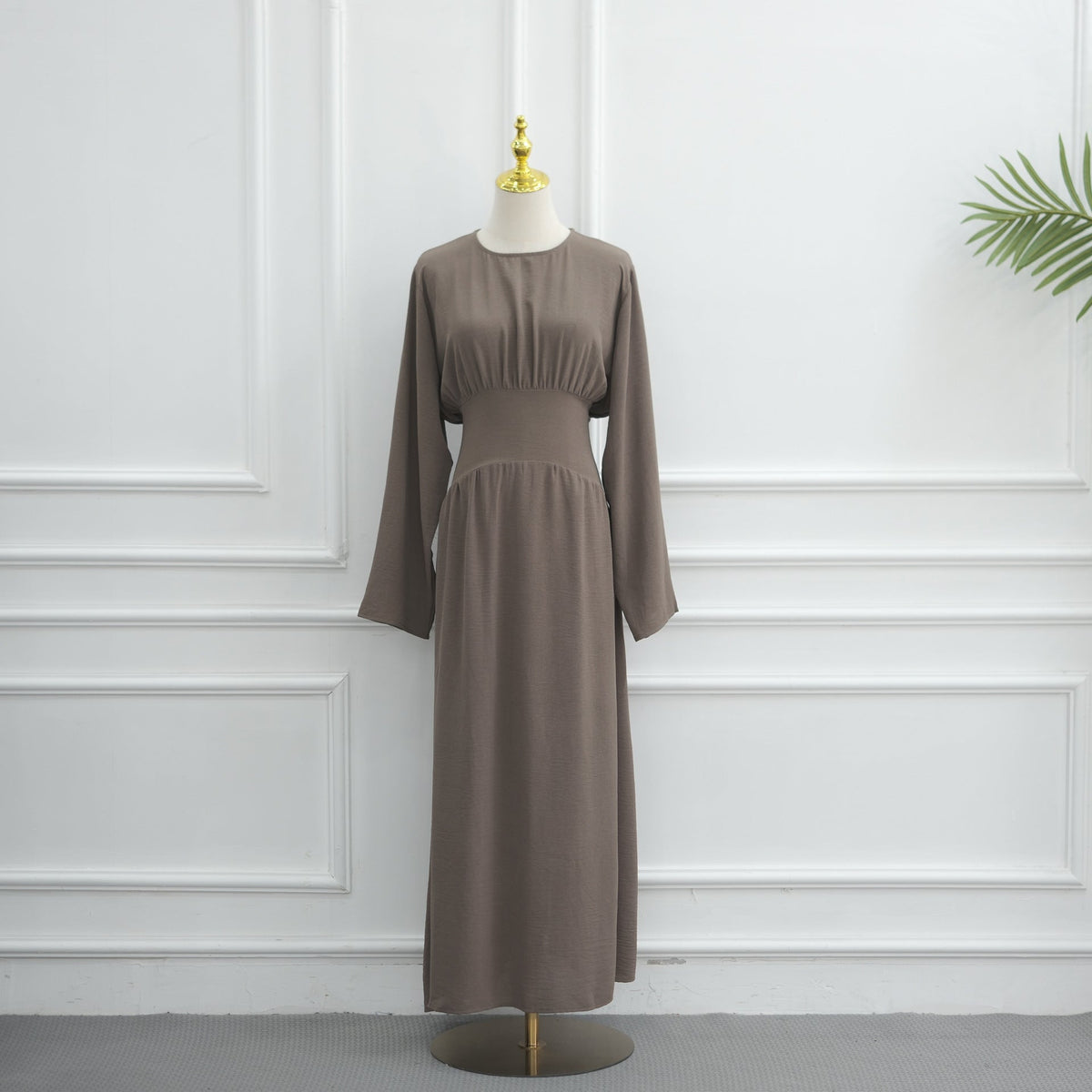 Draped folds falling from cinched waist on maxi dress