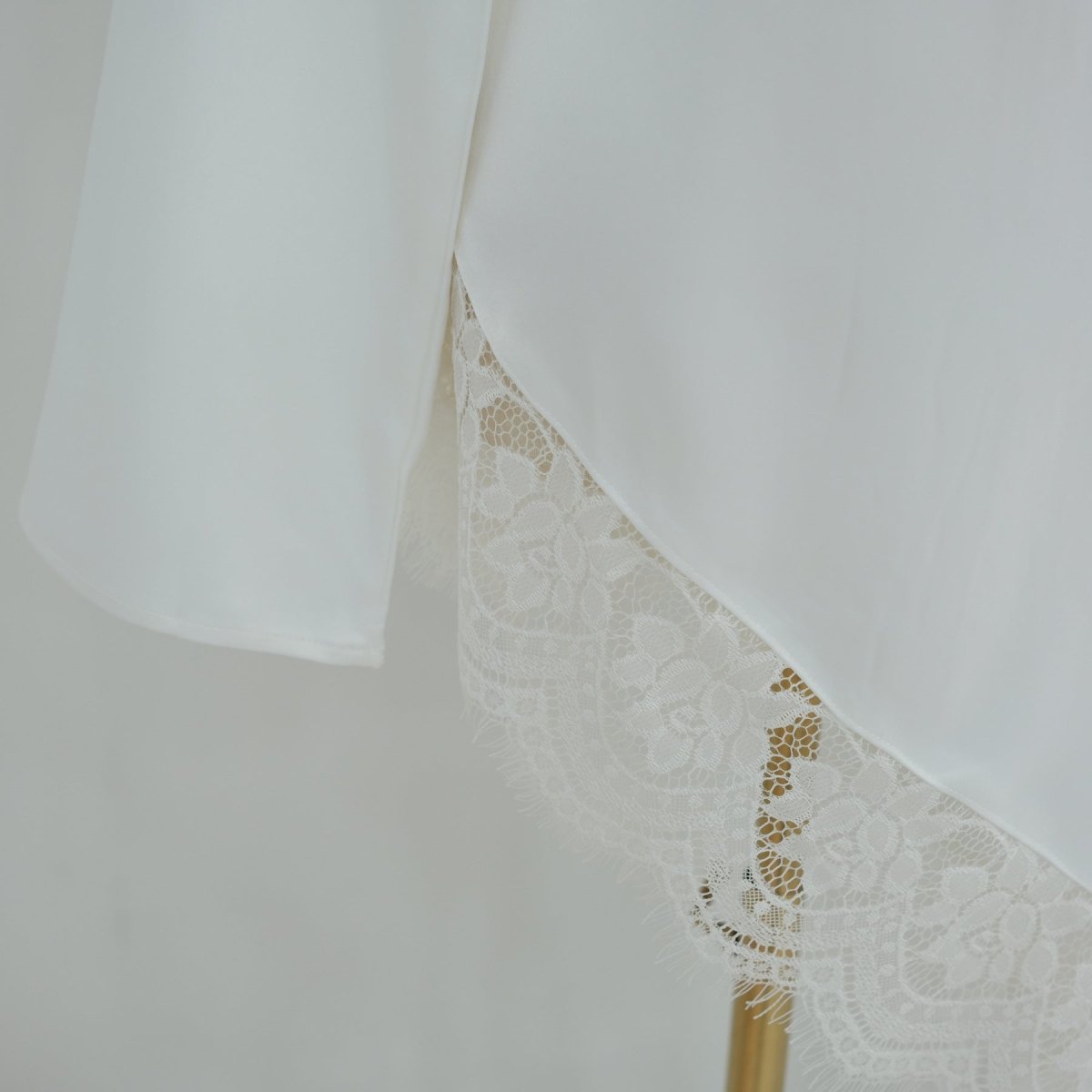 Three-quarter back angle showing contrast lace panel and bell sleeves