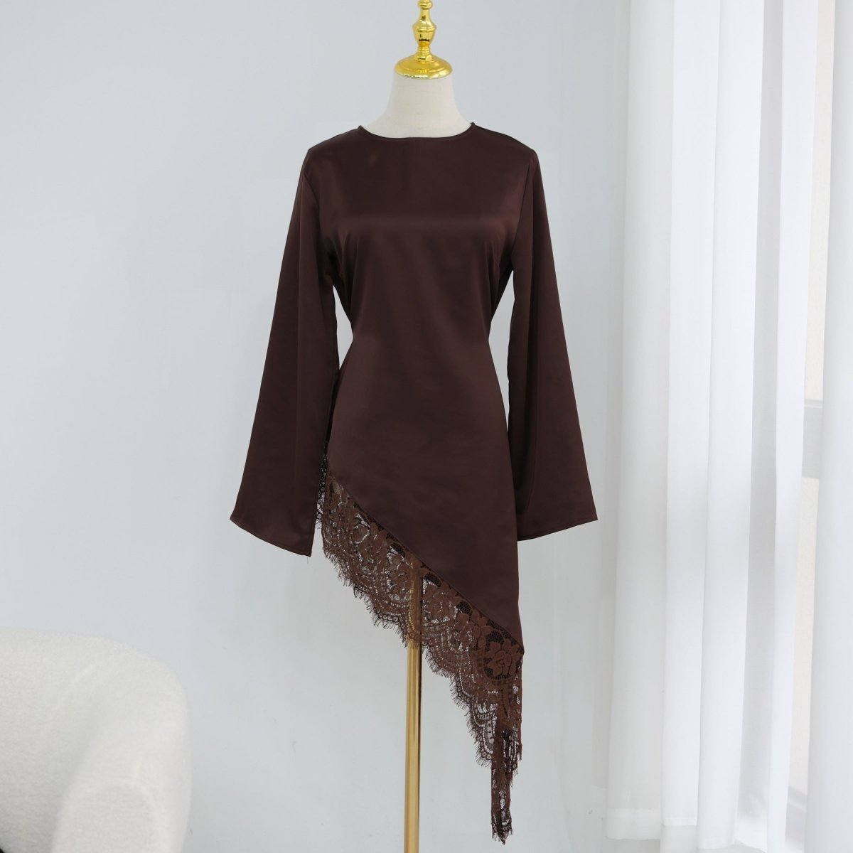 Overhead detail of contrast lace cuff and wide bell sleeve