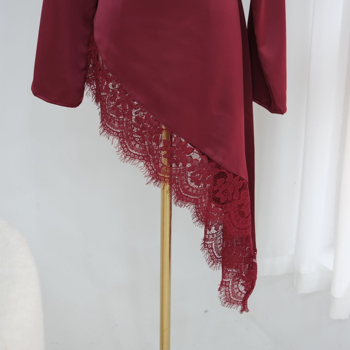 Full-length side view of bell sleeve satin top with fluid drape