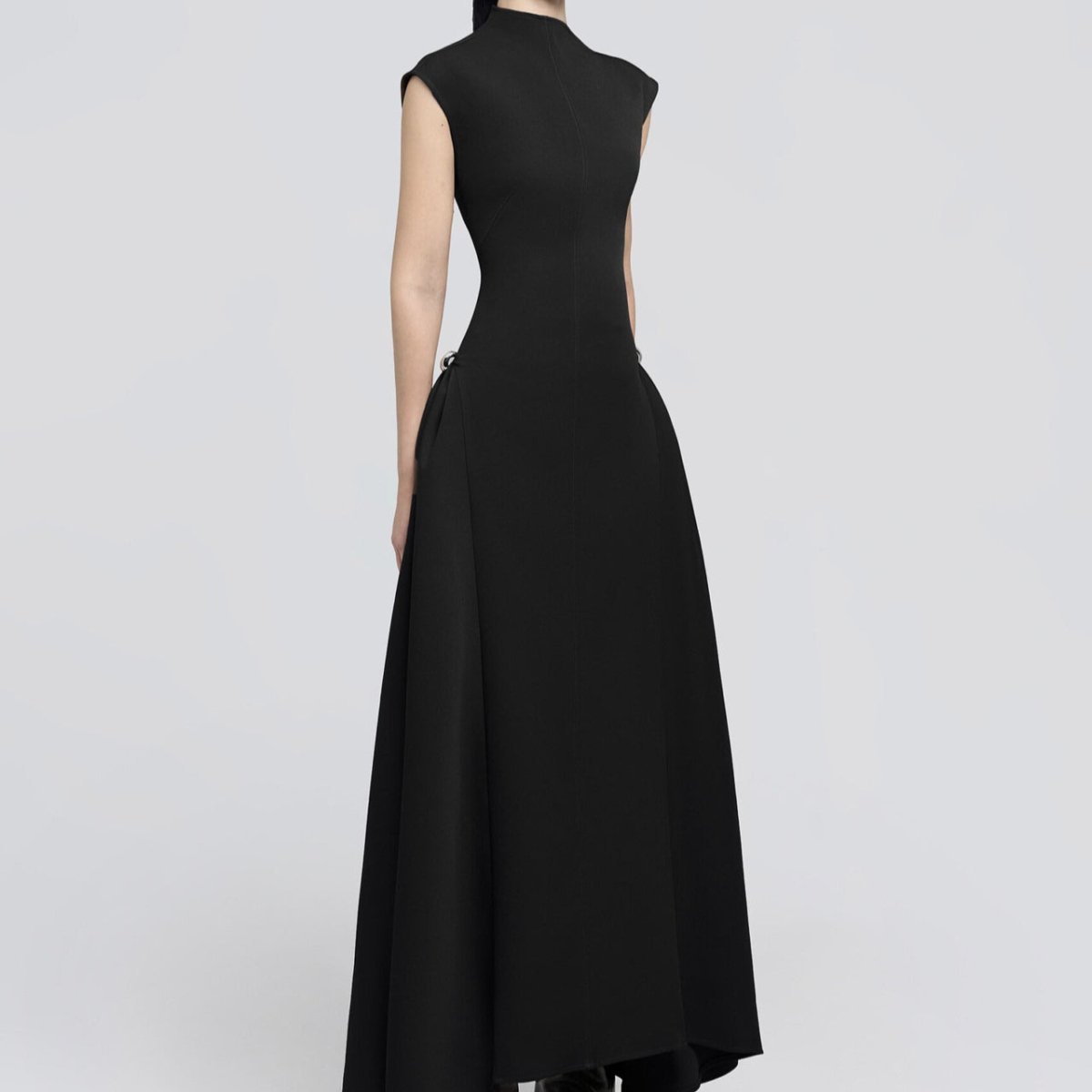 Minimalist sleeveless fitted maxi dress in black with clean architectural lines