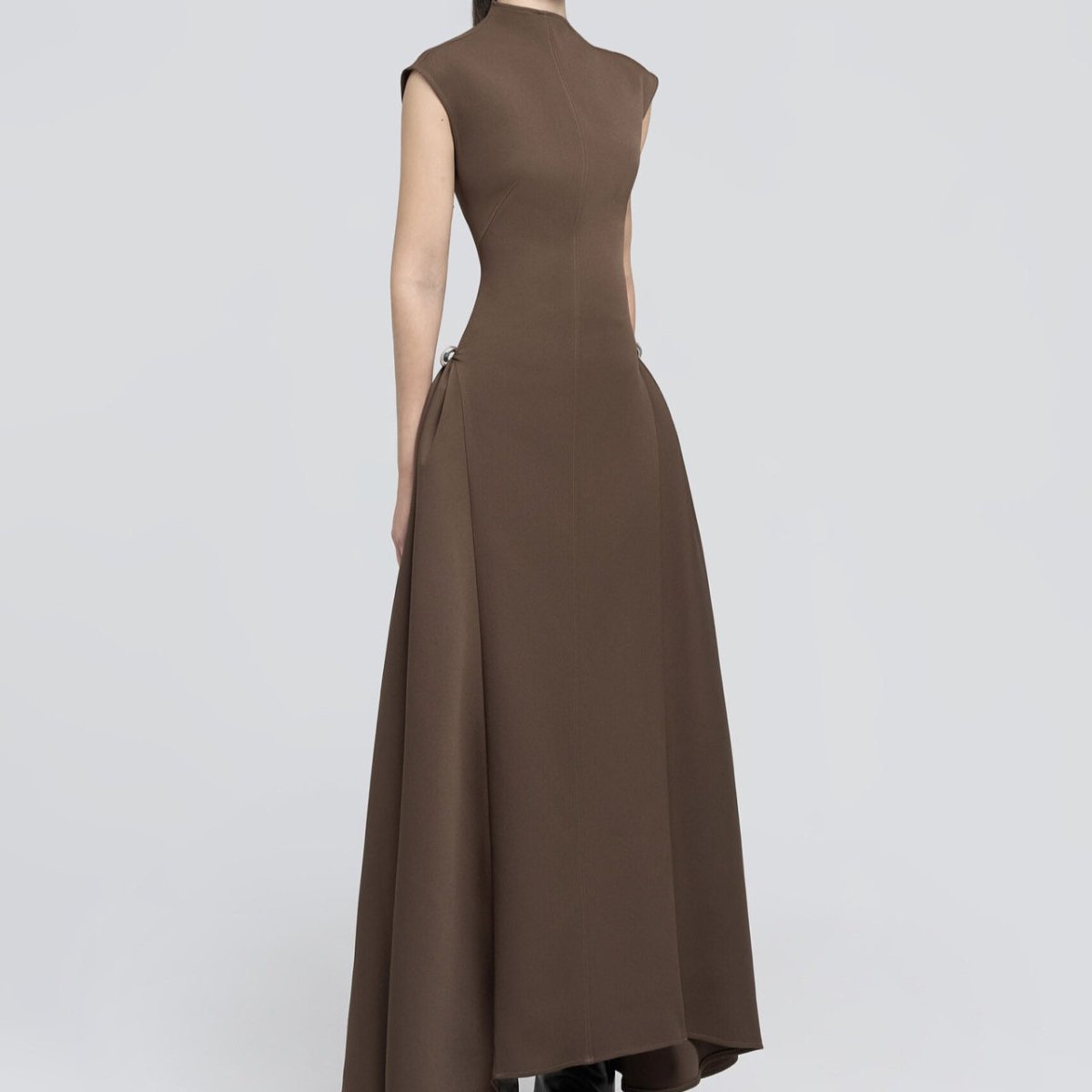 Black fitted gown with minimalist aesthetic and asymmetric silhouette