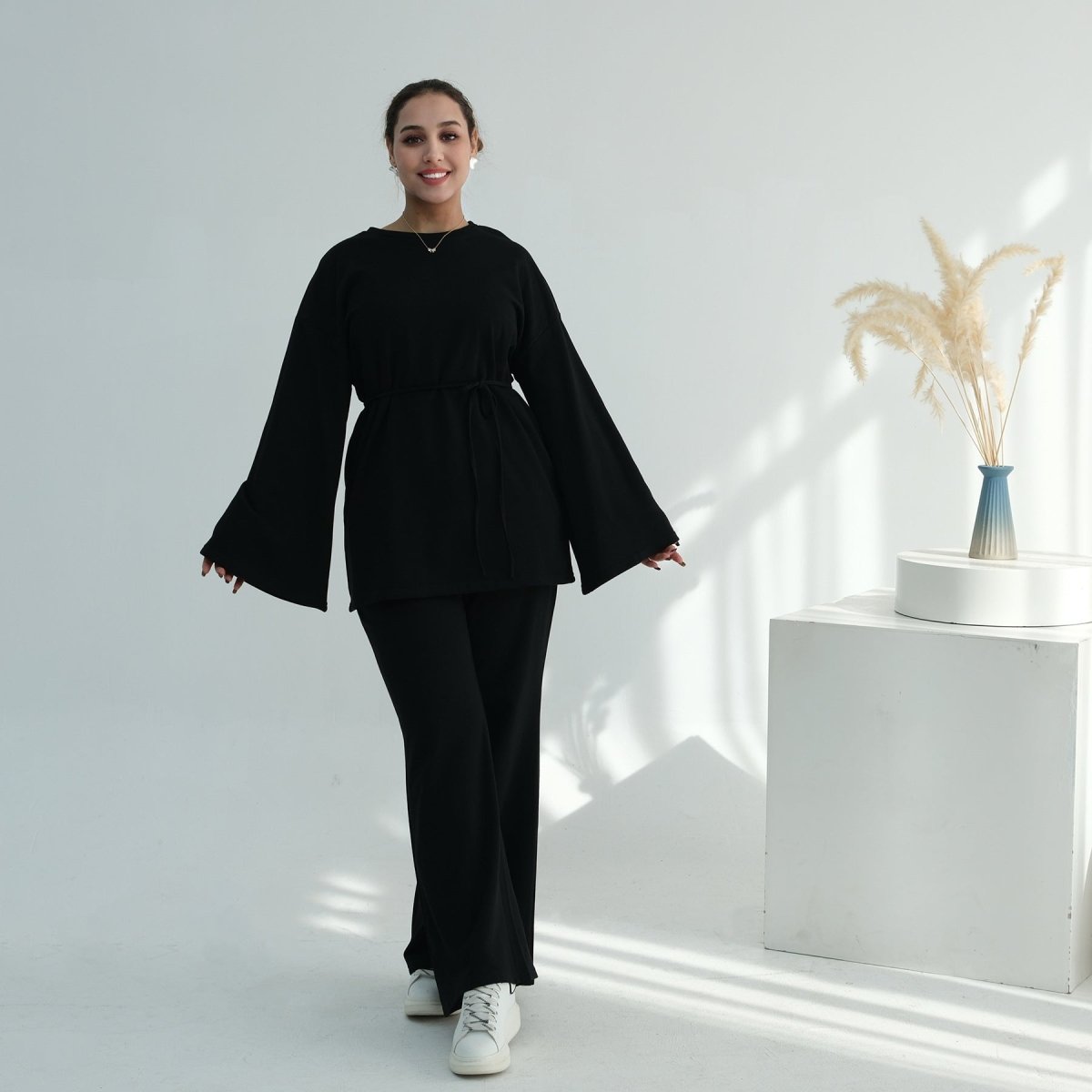 Three-quarter view of wide-leg trousers and oversized top co-ord