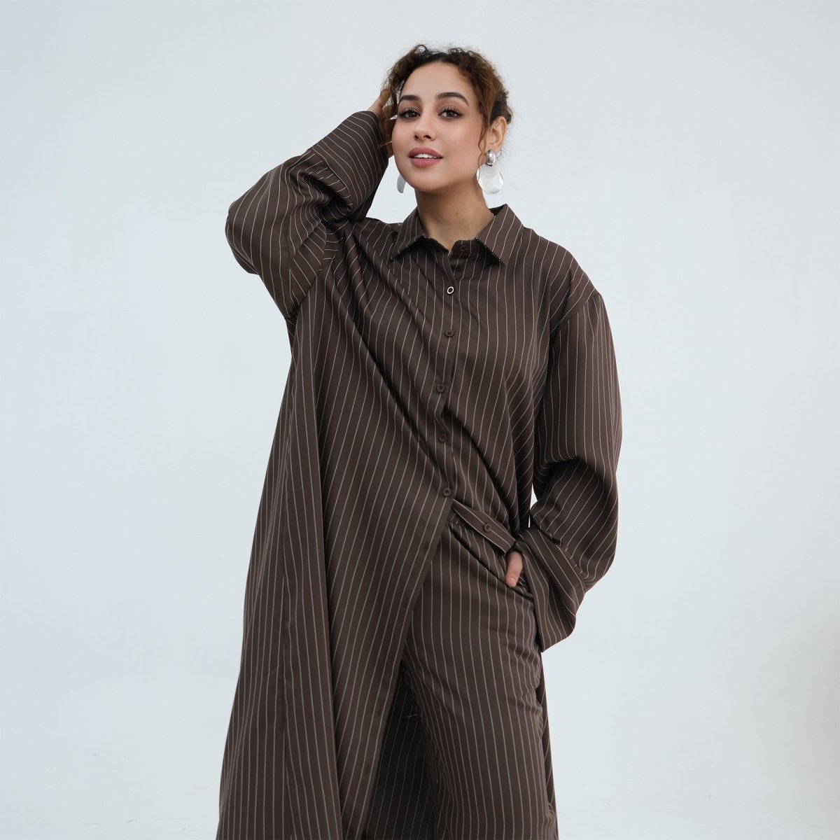 Spread collar close-up on the modest oversized pinstripe shirt