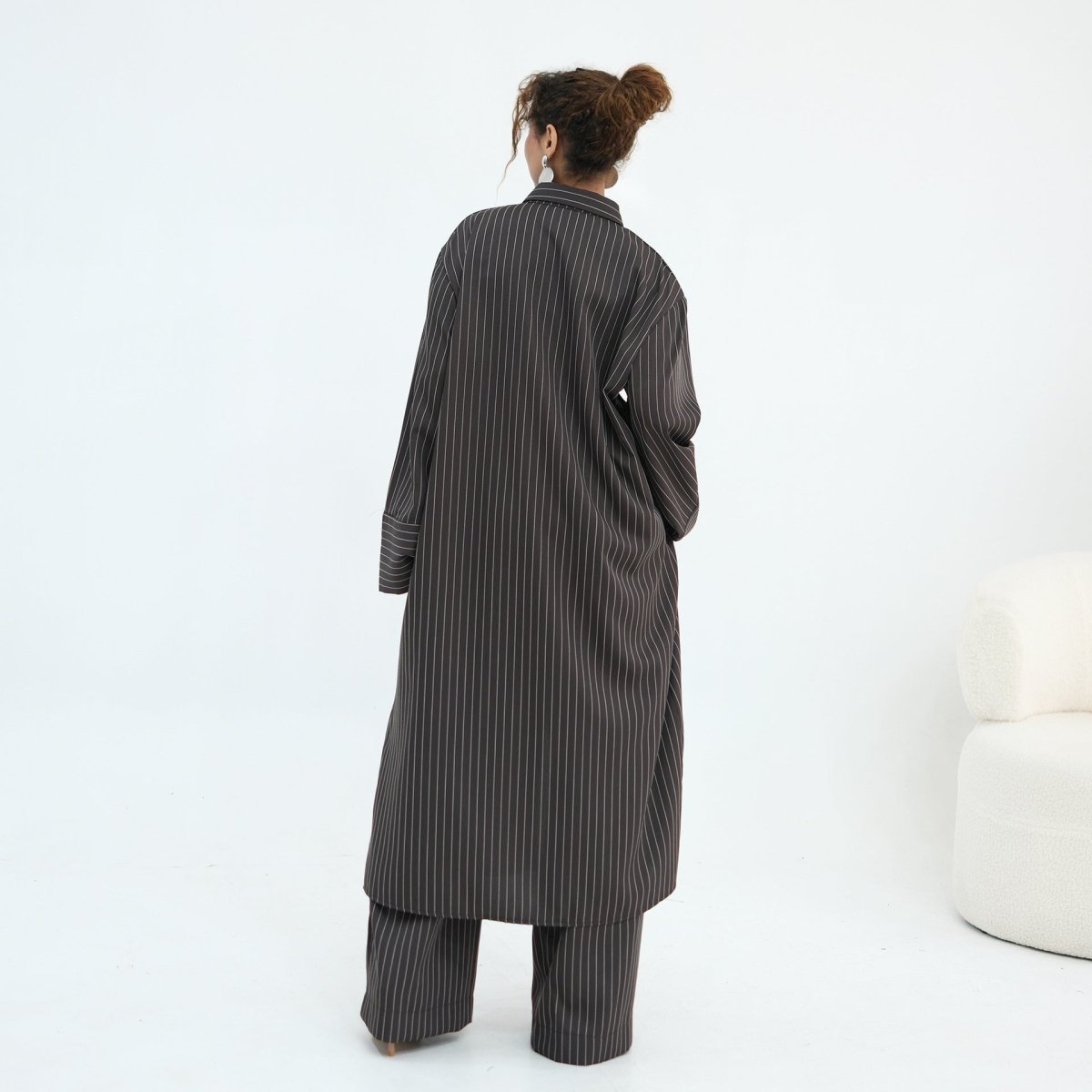 Overhead detail shot of fine tonal pinstripe across shirt and trouser fabric