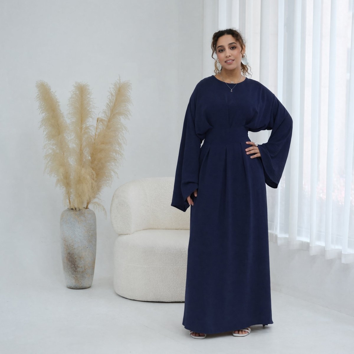 Round neckline detail on structured pleated maxi dress