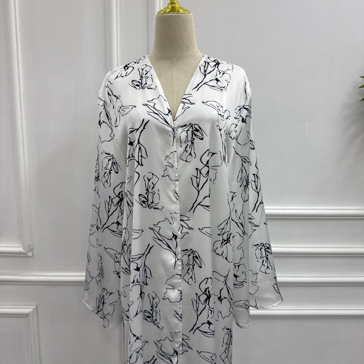 Back view of ink-brush floral open abaya with sweeping flared sleeves