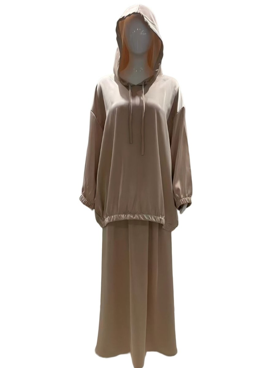 Flowing satin maxi skirt paired with hooded top for a coordinated look