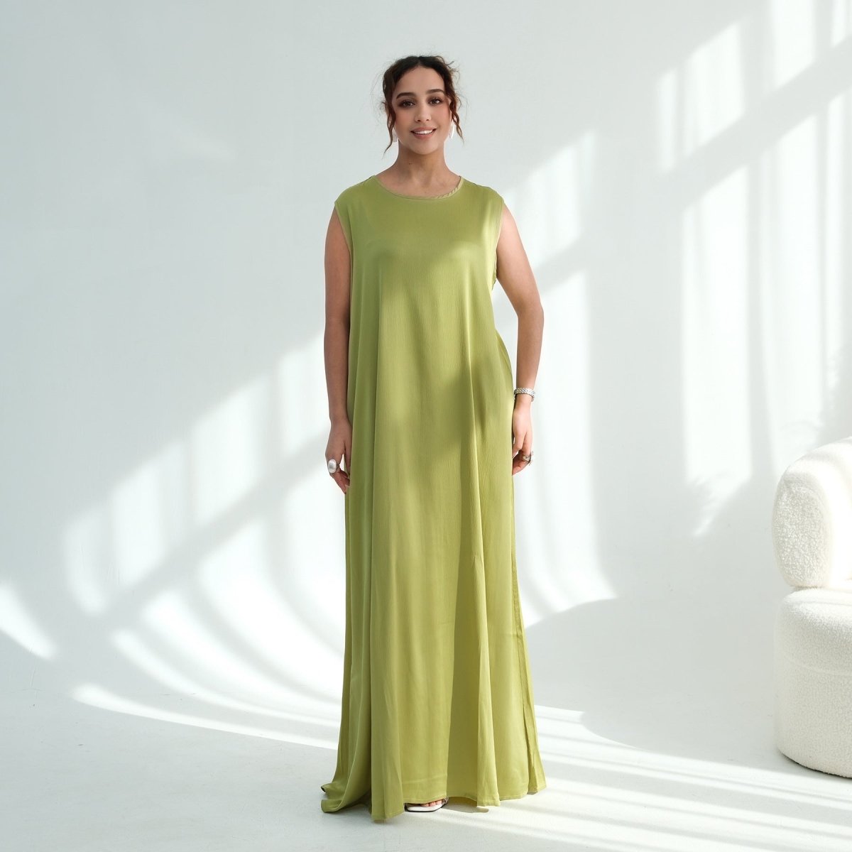 Model wearing minimalist sleeveless abaya — clean lines and effortless elegance