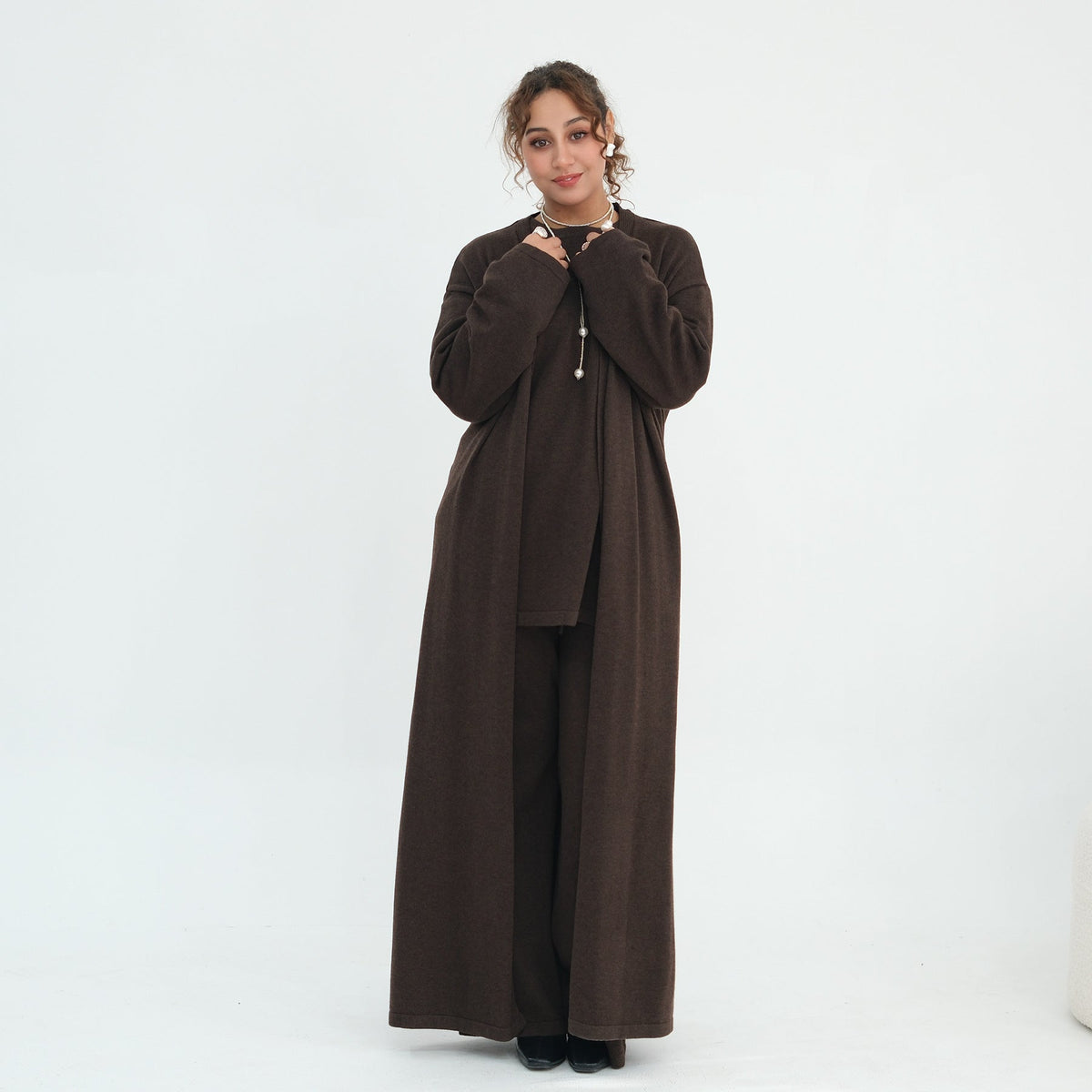 Flat lay of two-piece knit top and trousers