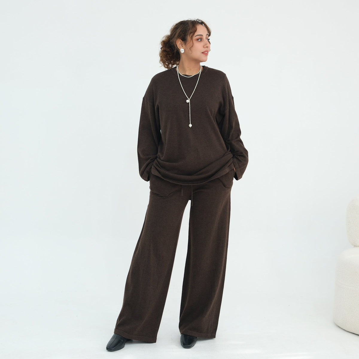 Styling shot of knit co-ord with hijab and ankle boots