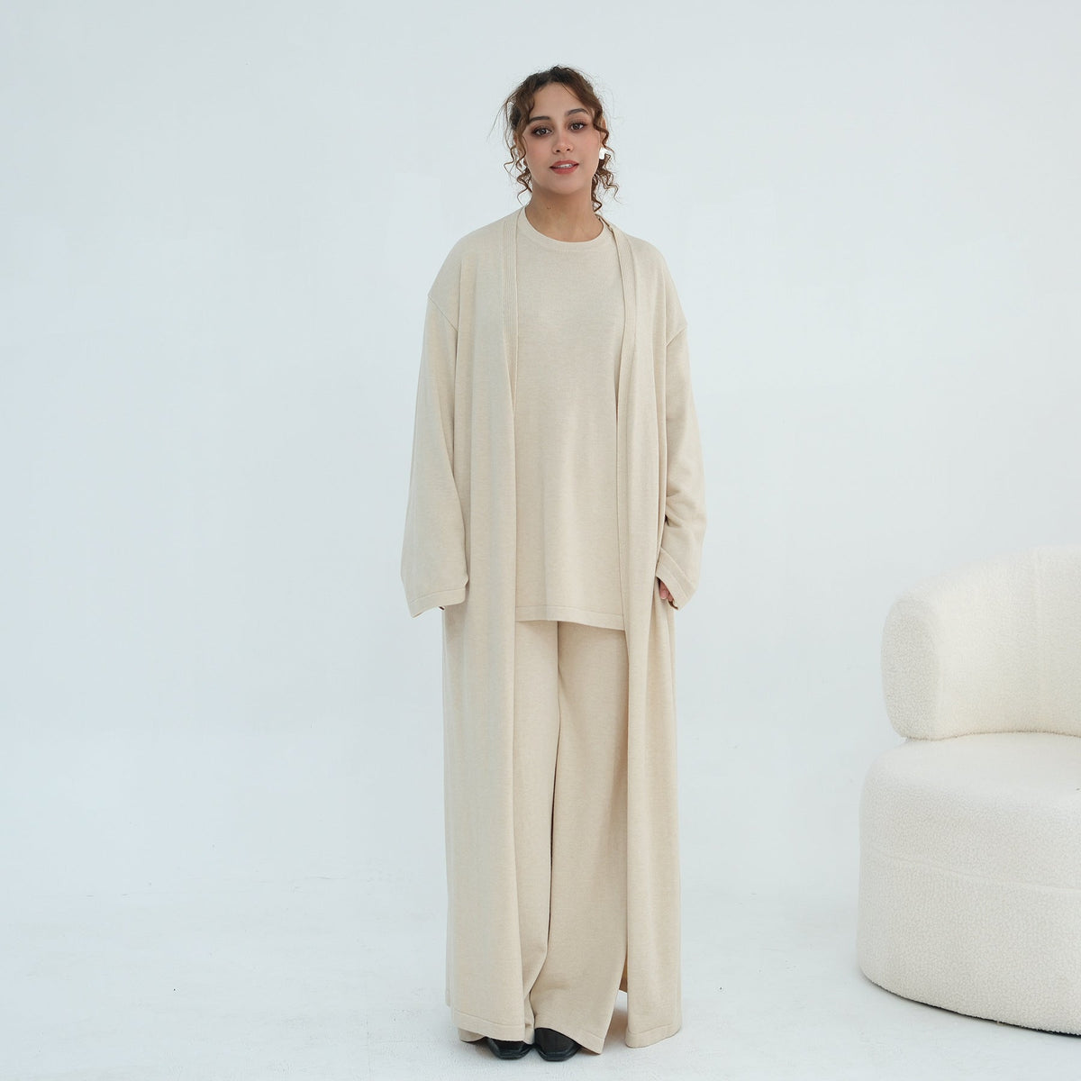 Model wearing jersey knit set with coordinating longline cardigan