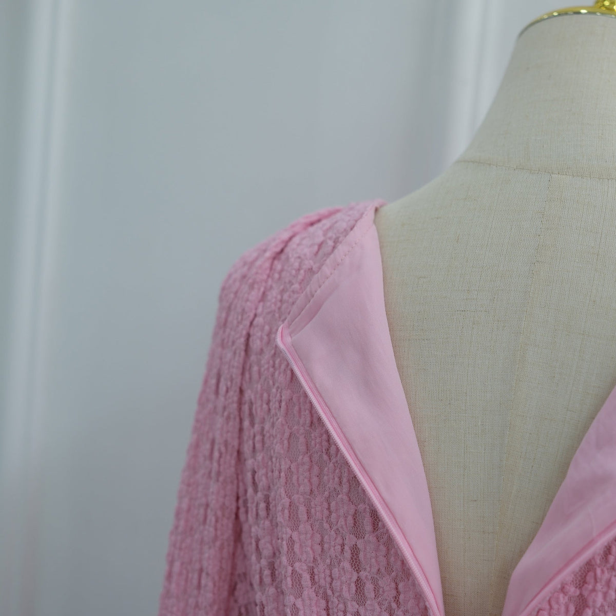 Textured floral relief pattern across entire dress surface