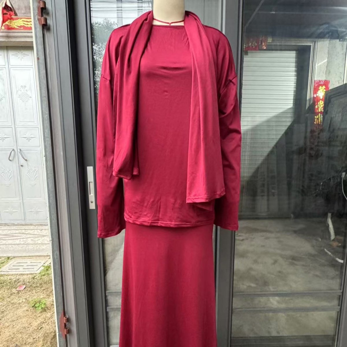 Two-piece black ensemble with practical built-in head covering