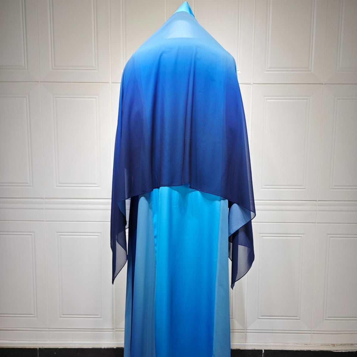 Side profile of navy colour-block abaya showing relaxed silhouette