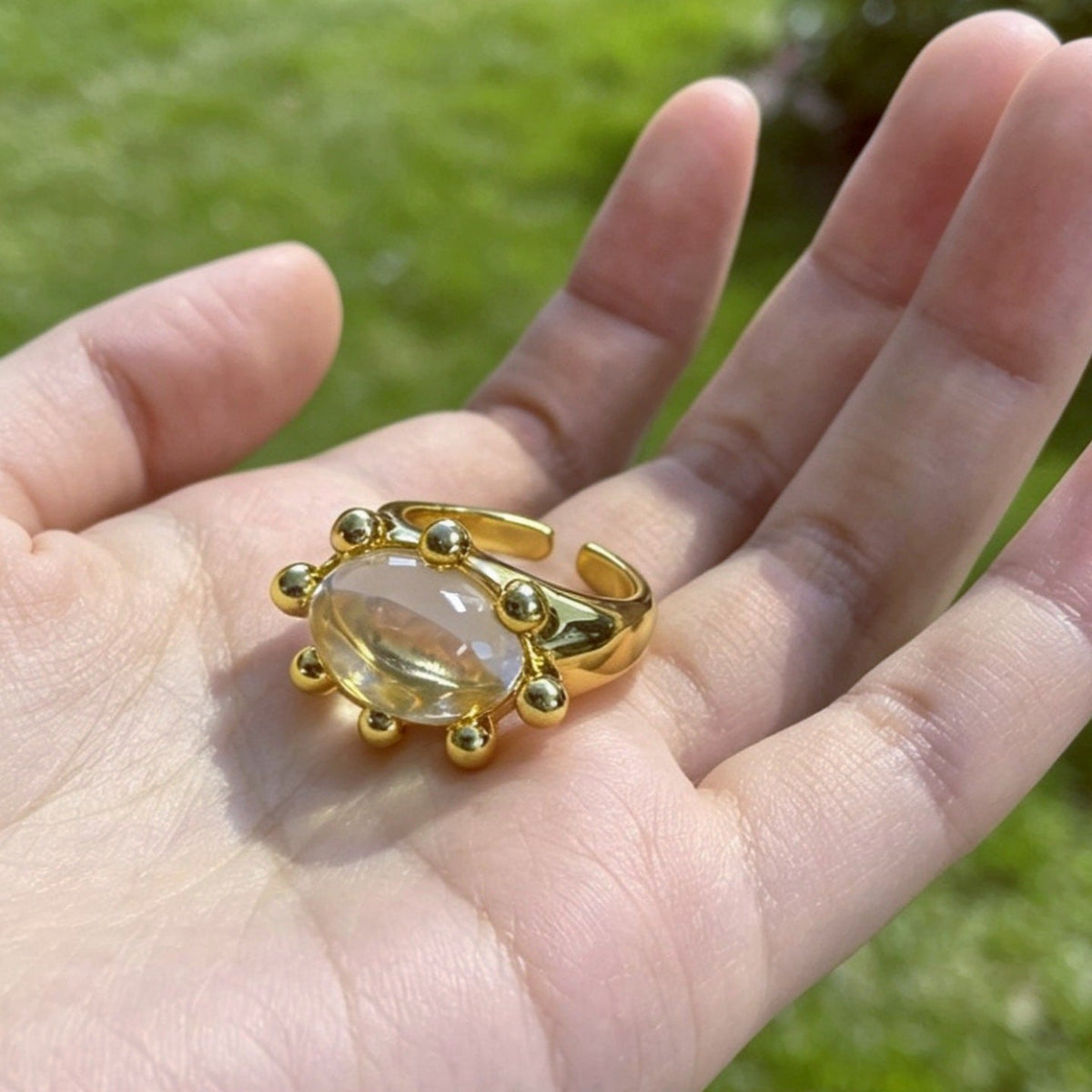 Crystal statement ring worn stacked with complementary jewellery