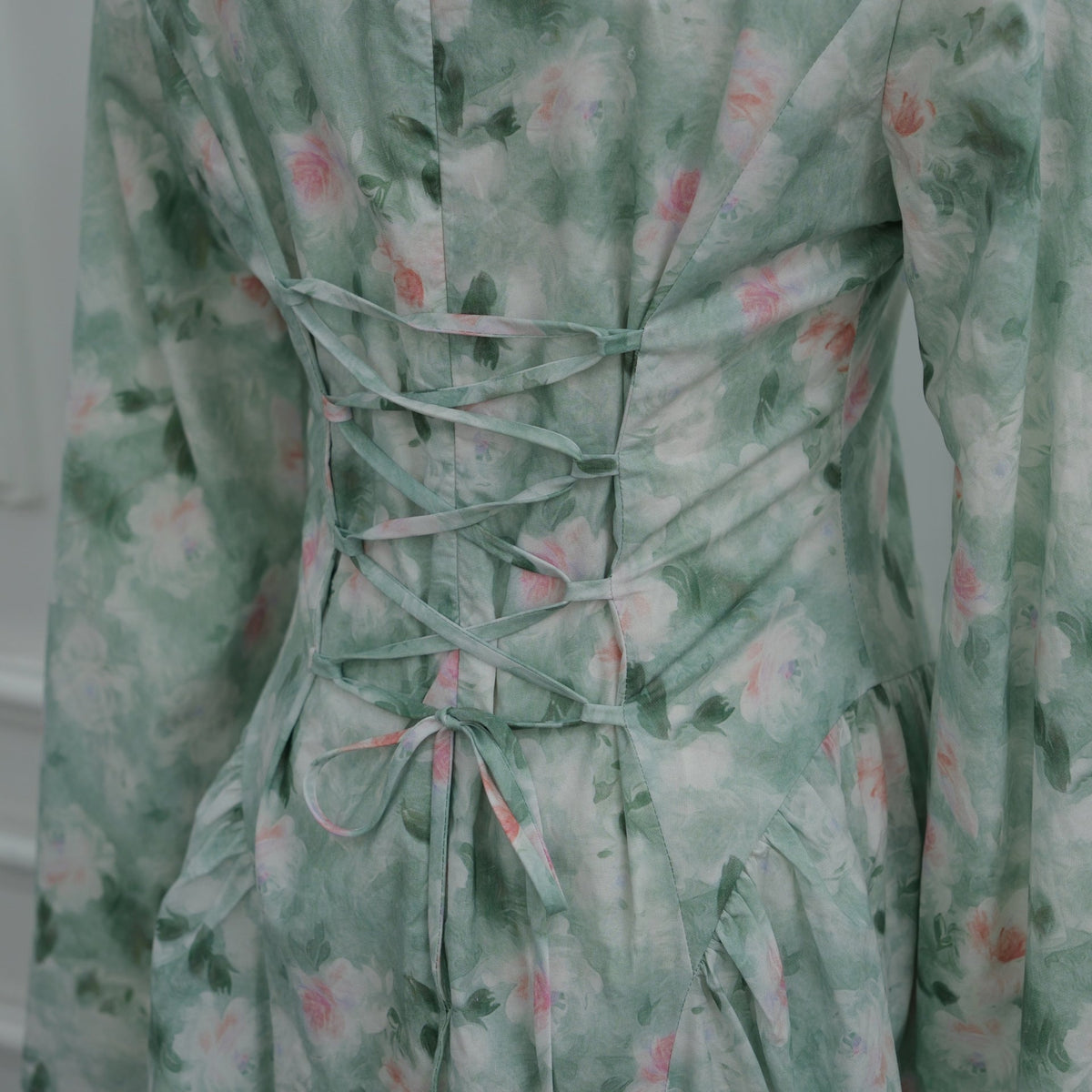 Mint green colourway back view of watercolour floral bell sleeve dress