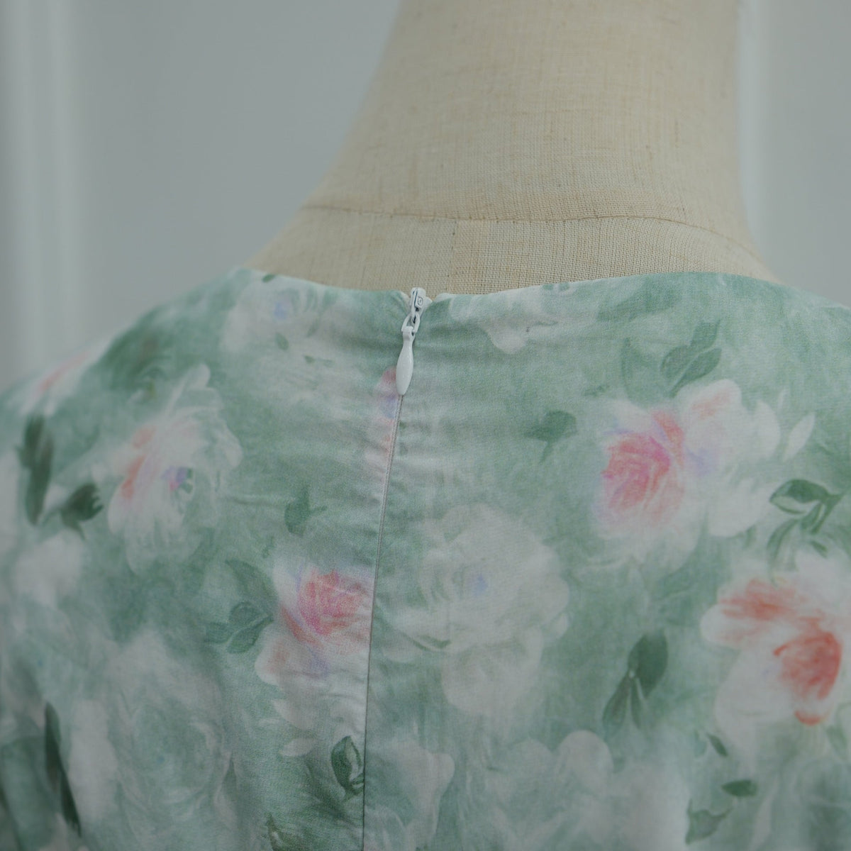 Draped skirt hem detail of floor-length modest floral print dress