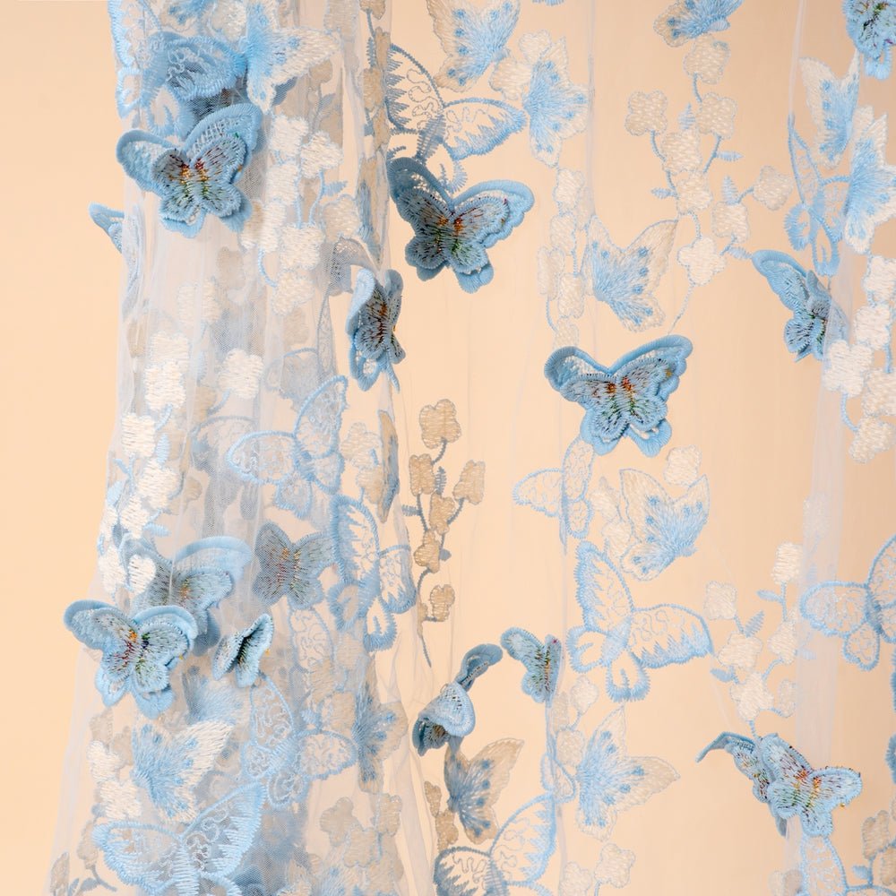 Layered view of 3D butterfly wings catching light on the open abaya fabric