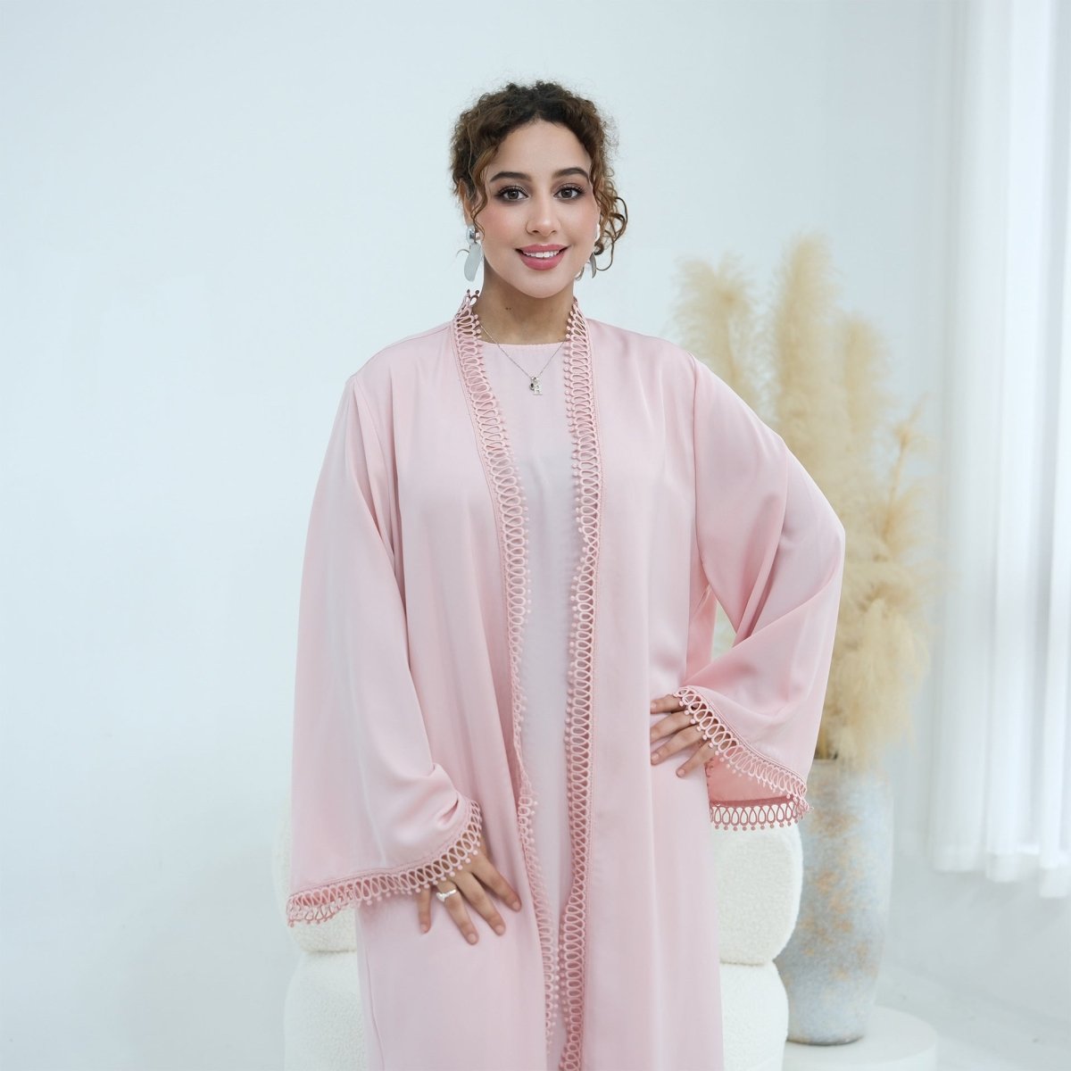 Open abaya front panels flowing open to reveal sleeveless inner dress