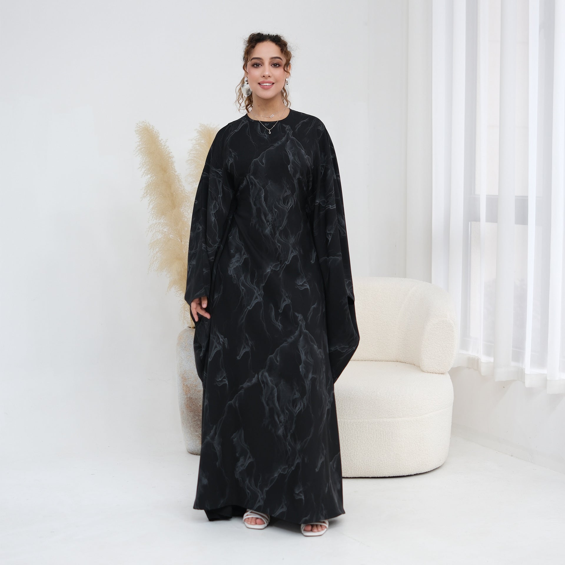 Full-length styling shot of gold print batwing sleeve modest maxi dress