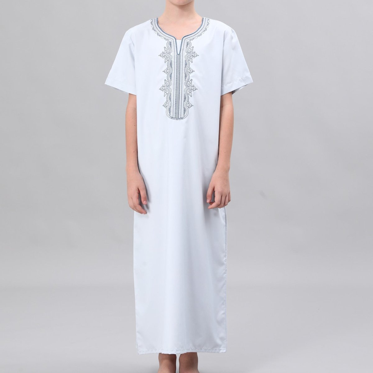 Boys' thobe in crisp white with black embroidery scroll pattern