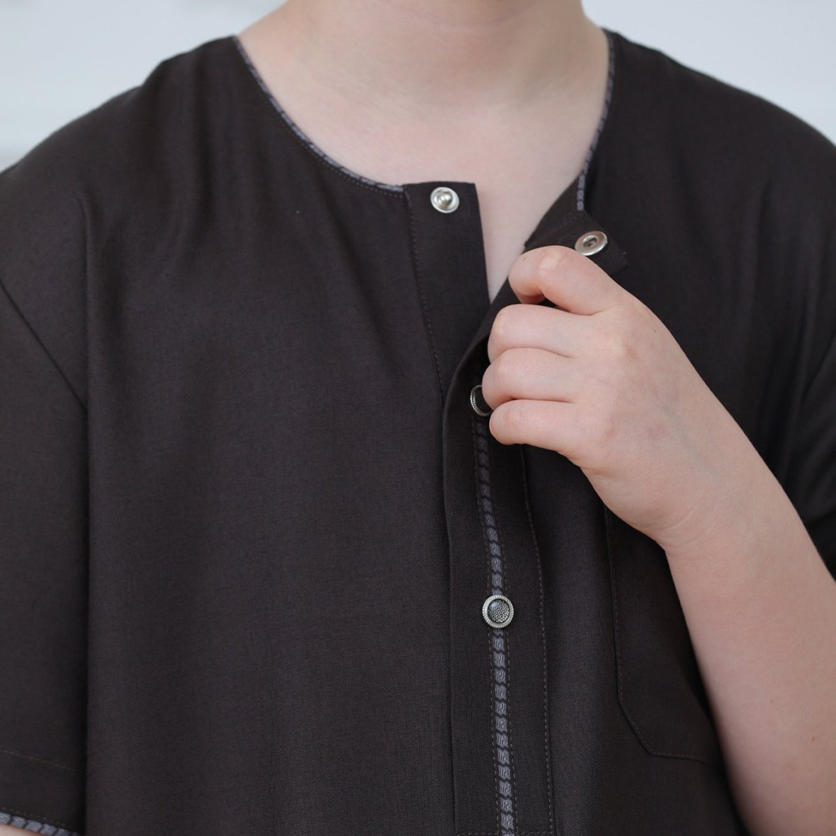 Back view of ankle-length boys' embroidered thobe
